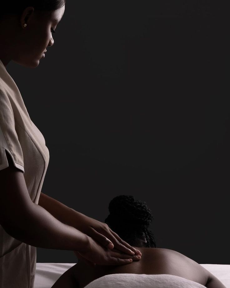 Professional therapist performing back massage